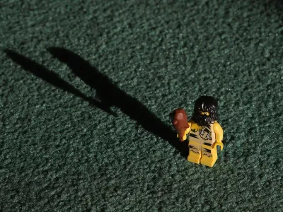Lego Caveman comes armed with a toy wooden club.