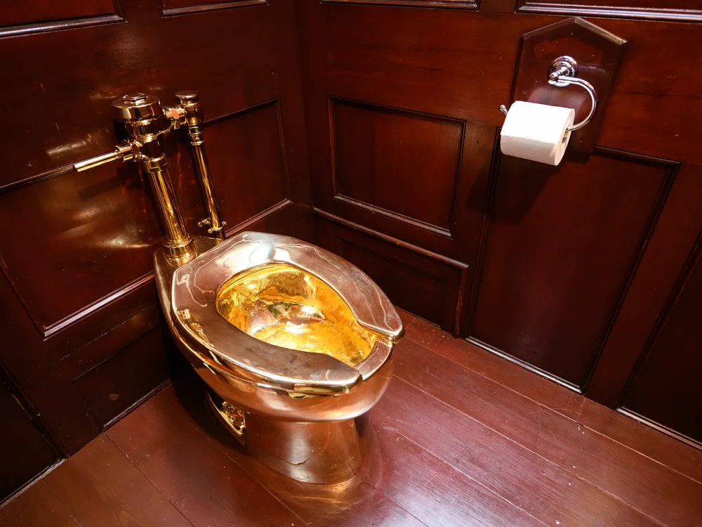 Gold toilet against rich wood paneling