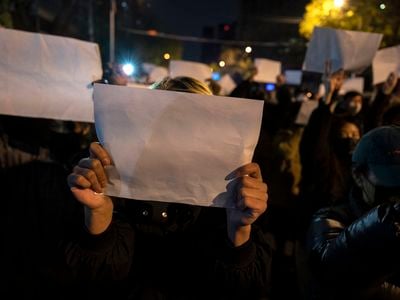 Protesters in Beijing hold up white sheets of paper during a November 27 protest against China&#39;s strict zero-Covid policy.