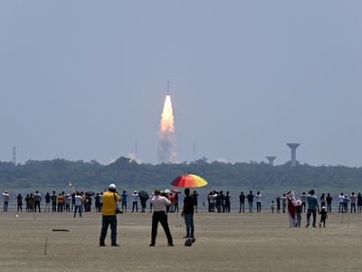 Onlookers watch as a rocket carrying the Aditya-L1 spacecraft launches. The mission will study the sun&#39;s outer layers and the influence of solar activity on the solar system.