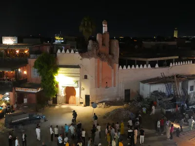 People gather around the damaged Kharbouch Mosque on September 9, 2023 in Marrakesh, Morocco.