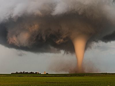 A tornado churns up dust at dusk near Traer, Iowa.